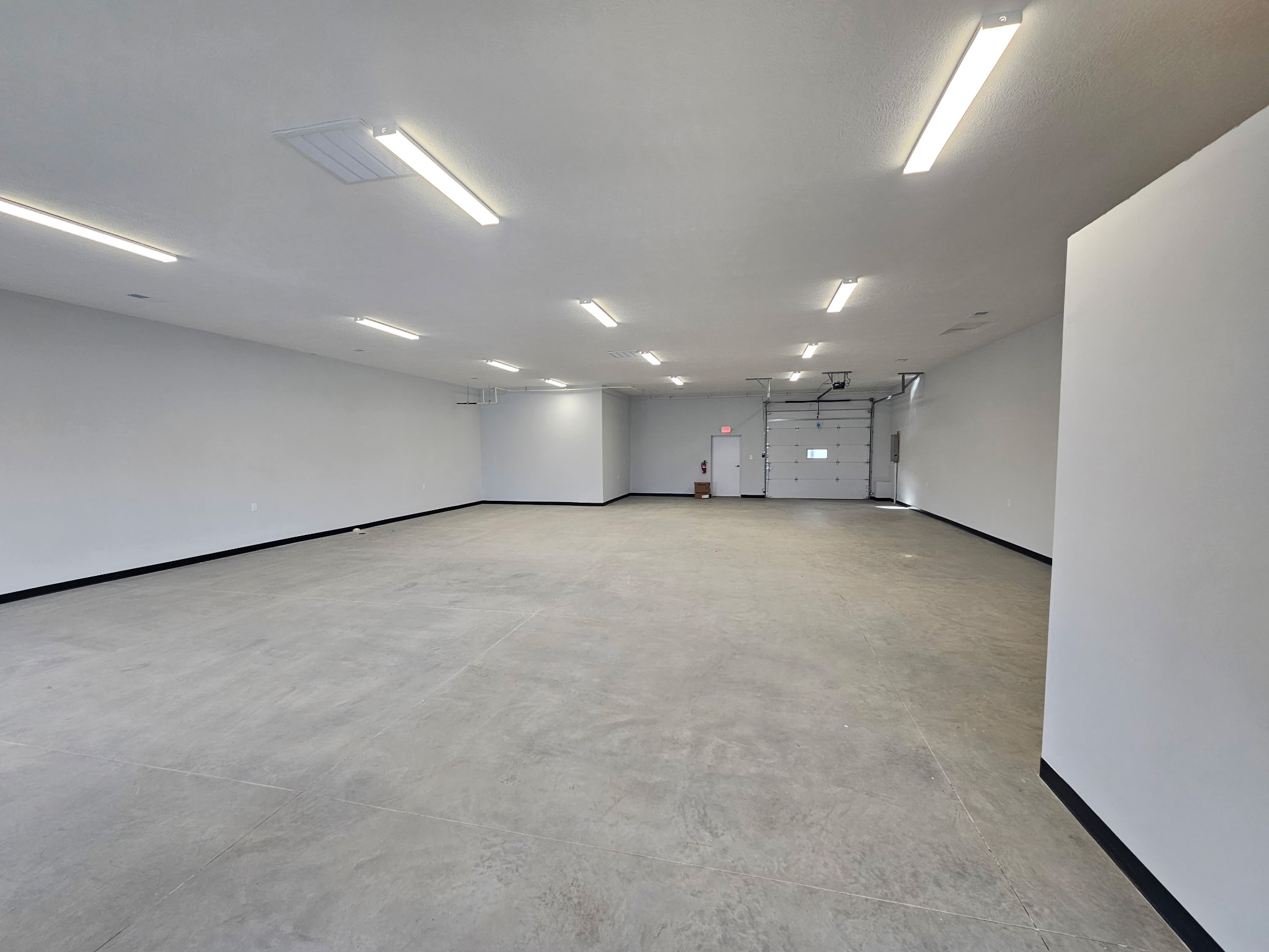 Closer front view of Buckeye Flex Space suites with business signs and vehicles in the lot